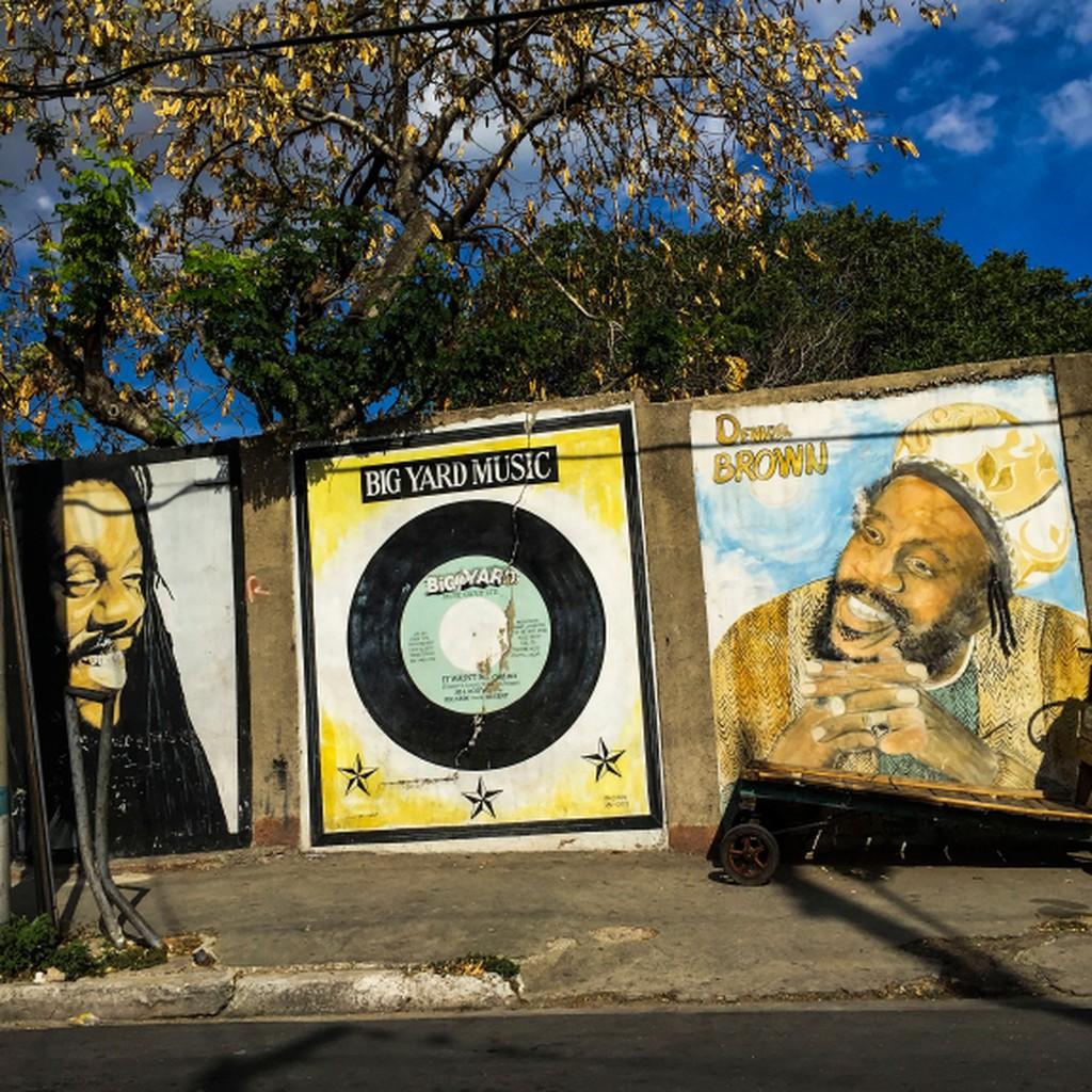 Photo of murals on a wall showing musicians and a vinyl record